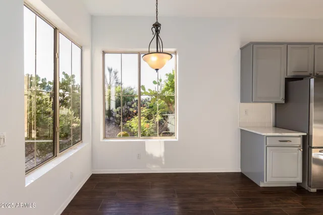 a view of a kitchen with a stove wooden floor and a window