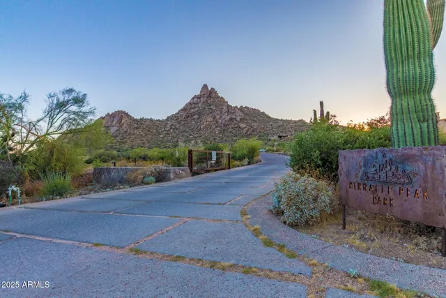 a view of a garden with a barn in front of it