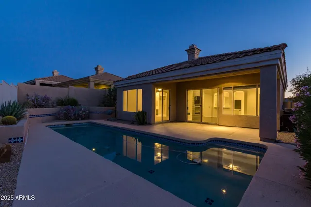 a view of backyard with a table and chairs
