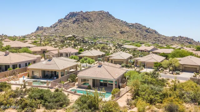 a front view of a building with a mountain