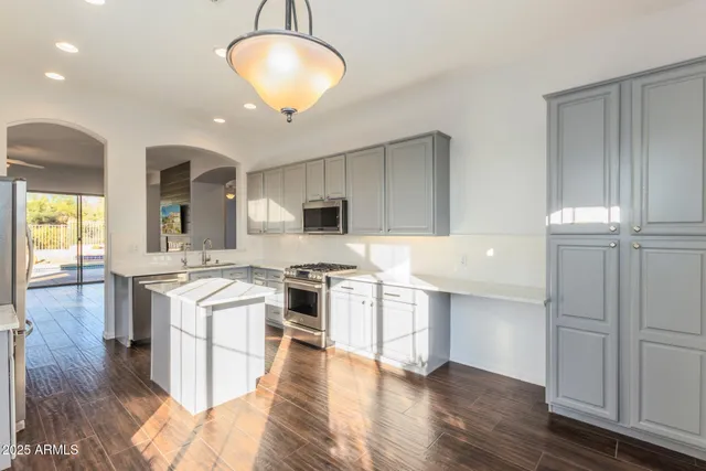 a large kitchen with cabinets and wooden floor