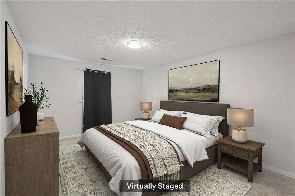 1145 Christian Circle Southeast Conyers, GA 30013 - Photo 11 of 18 a bedroom with a bed and a potted plant