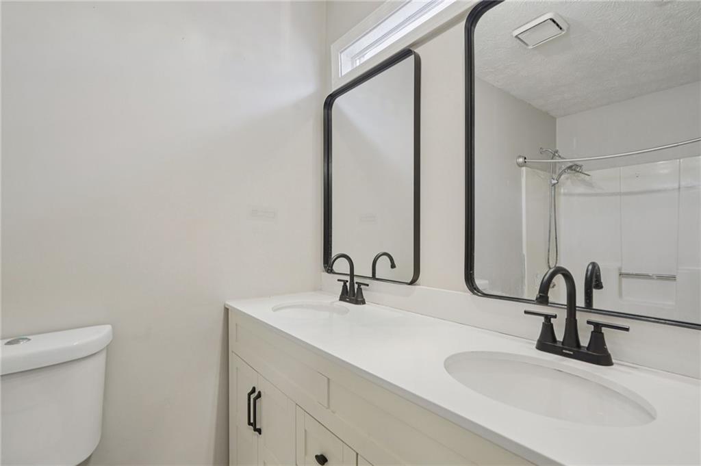 1145 Christian Circle Southeast Conyers, GA 30013 - Photo 13 of 18 a bathroom with a sink and a mirror