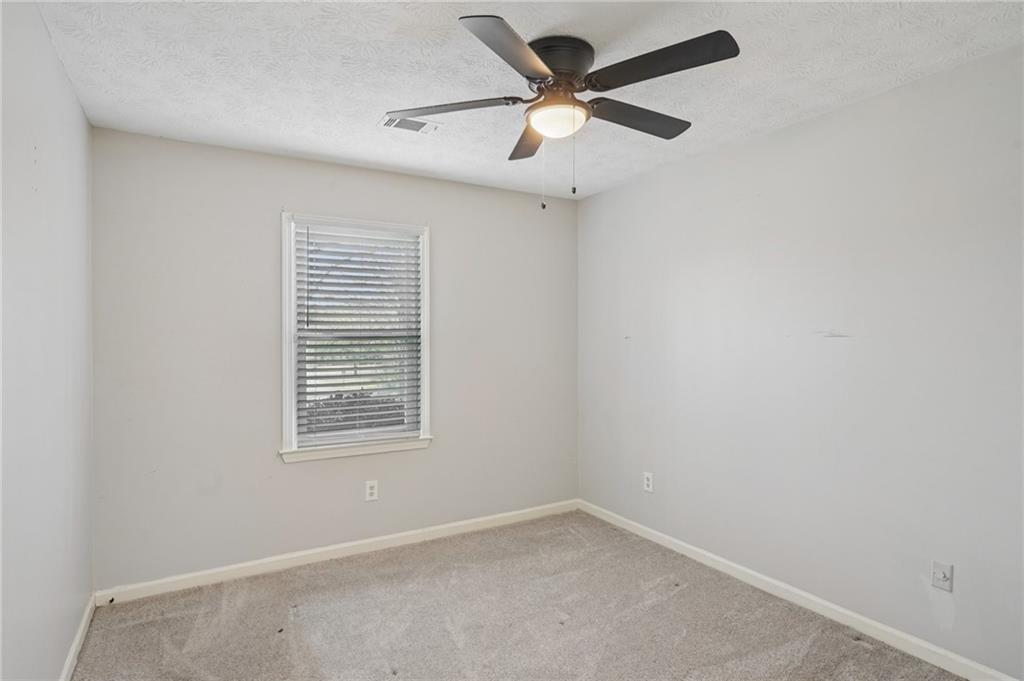 1145 Christian Circle Southeast Conyers, GA 30013 - Photo 14 of 18 an empty room with a window and a fan