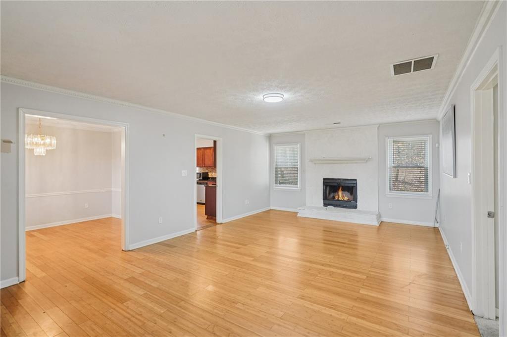 1145 Christian Circle Southeast Conyers, GA 30013 - Photo 3 of 18 a view of empty room with wooden floor and fireplace