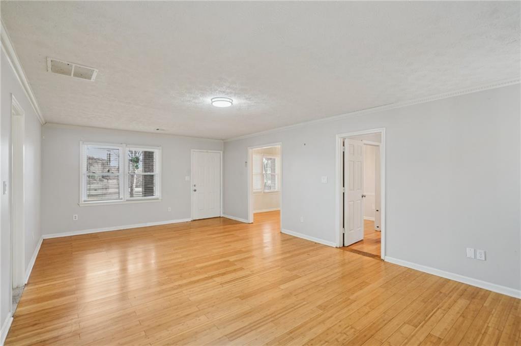 1145 Christian Circle Southeast Conyers, GA 30013 - Photo 4 of 18 a view of empty room with wooden floor and fan