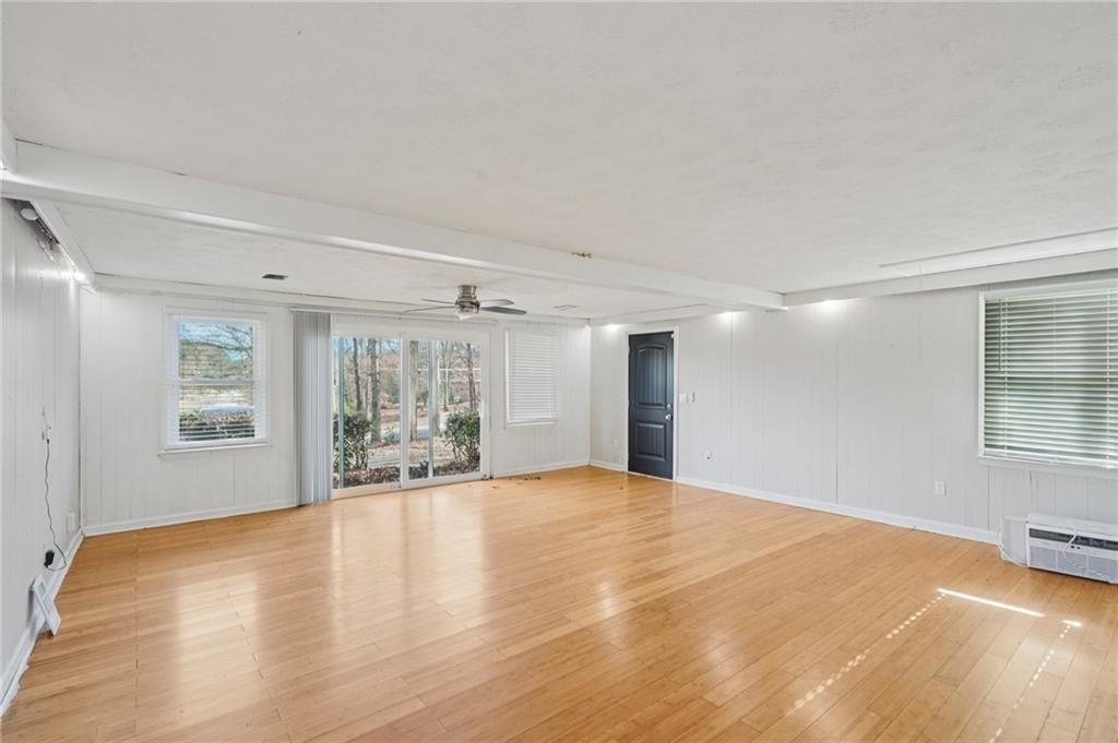 1145 Christian Circle Southeast Conyers, GA 30013 - Photo 9 of 18 a view of an empty room with a window and wooden floor