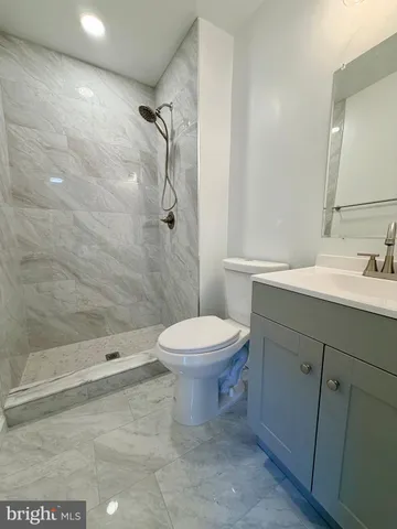 a bathroom with a toilet a sink and shower