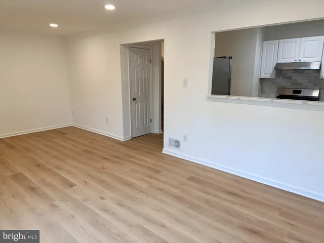 a view of a kitchen with wooden floor and a sink
