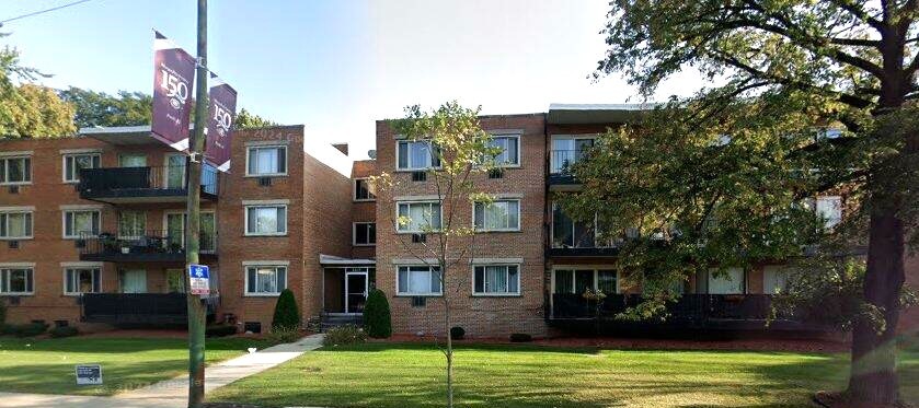 2215 West 111th Street, Unit 101 Chicago, IL 60643 - Photo 1 of 39 a view of a brick house next to a yard with big trees