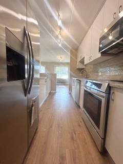 2215 West 111th Street, Unit 101 Chicago, IL 60643 - Photo 14 of 39 a kitchen with stainless steel appliances granite countertop a stove a sink and a microwave