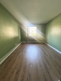 2215 West 111th Street, Unit 101 Chicago, IL 60643 - Photo 23 of 39 an empty room with wooden floor and windows