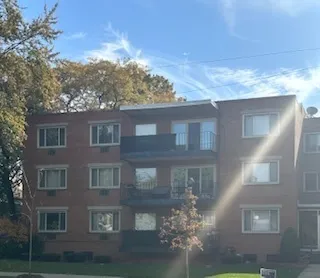 a view of a tall building next to a road