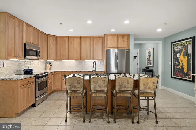 a bedroom with two beds and a chandelier