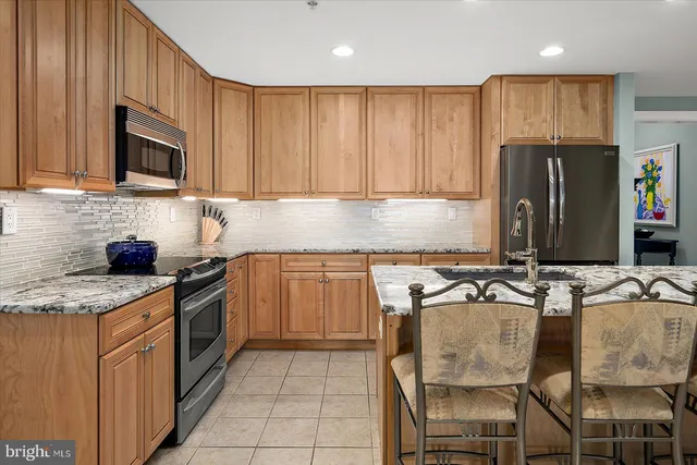 a living room with furniture fireplace and a large window