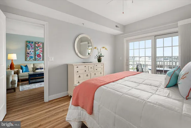 a large bed sitting in a bedroom next to a window