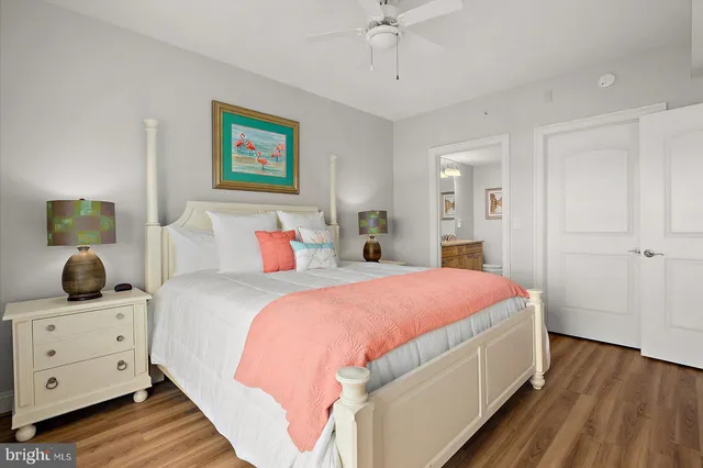 a bathroom with a granite countertop toilet sink and mirror