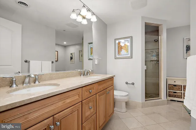 a view of walk in closet with clothes