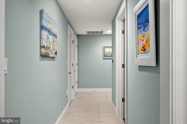 an aerial view of a city with ocean view in back