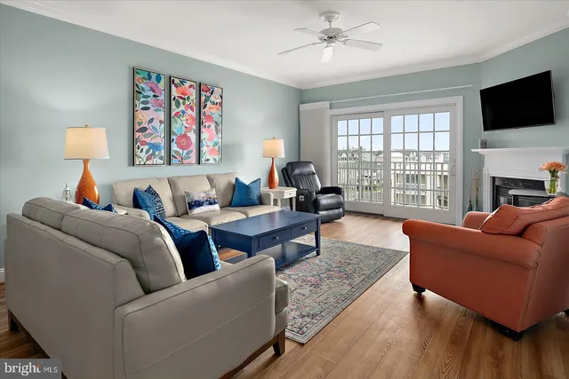 a dining room with furniture a chandelier and wooden floor
