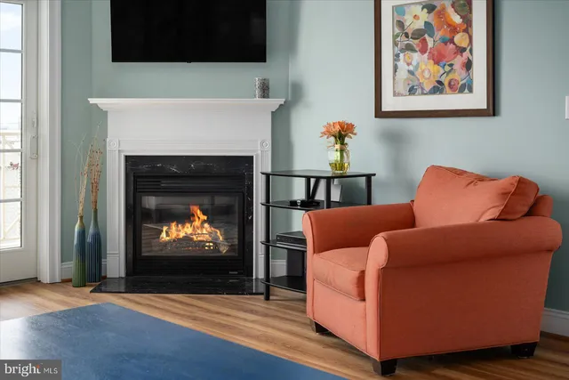 a kitchen with stainless steel appliances granite countertop a stove top oven a sink a dining table and chairs