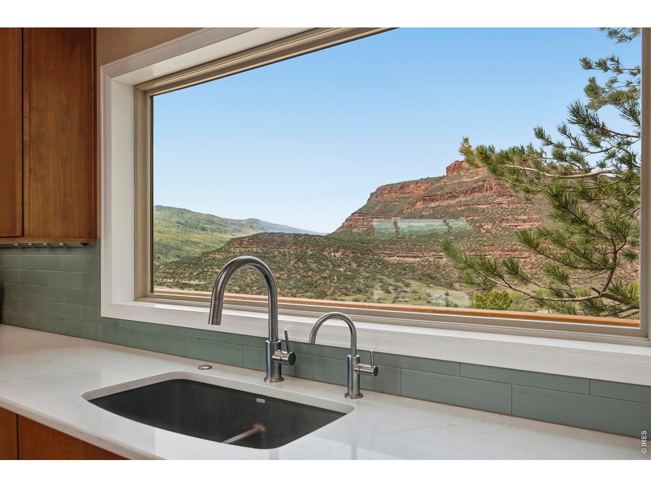 6925 Milner Mountain Ranch Road Fort Collins, CO 80526 - Photo 14 of 40 Even chores become a pleasure with breathtaking views from the kitchen sink, framing a wildlife watering hole and the beauty beyond.