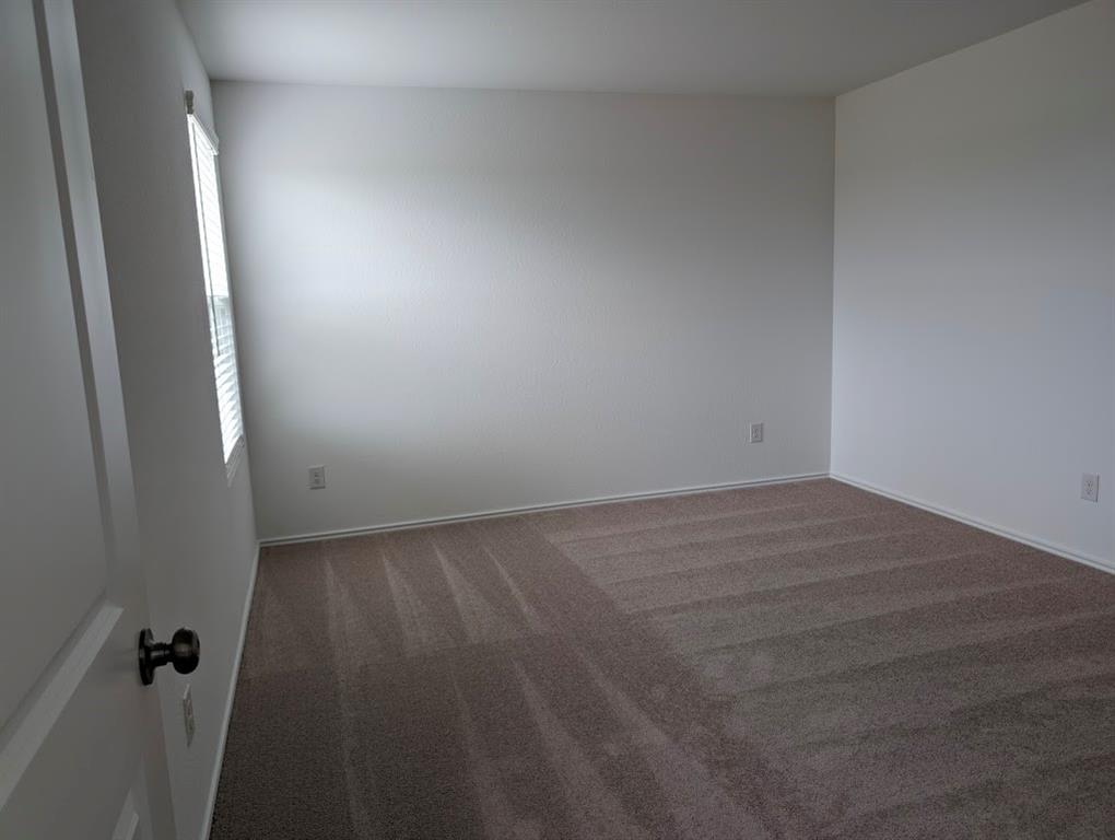 564 Rancho Del Cielo Loop Jarrell, TX 76537 - Photo 6 of 14 An inviting, freshly carpeted bedroom awaits your personal touch.