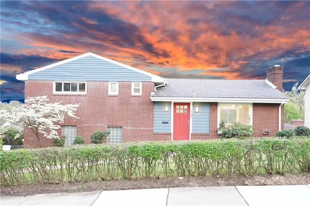 a front view of a house with a garden