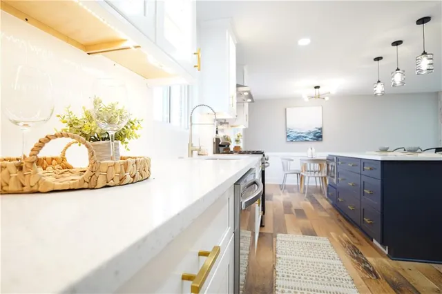 a kitchen with a sink a counter space and appliances
