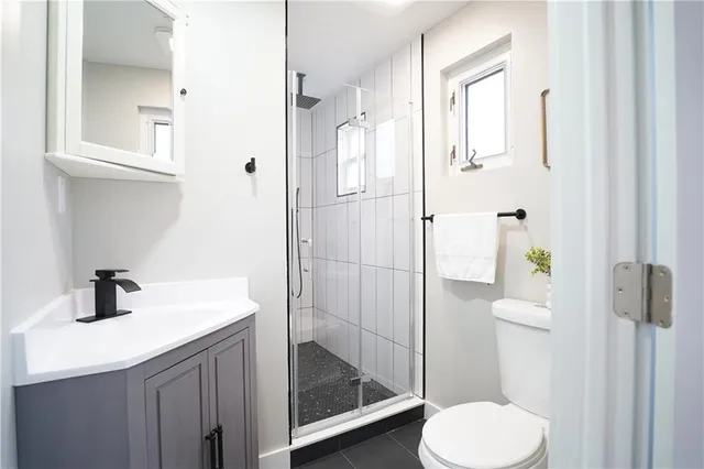 a bathroom with a sink toilet and shower