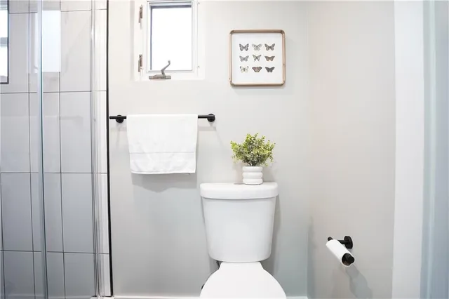 a white toilet sitting next to a bathroom sink