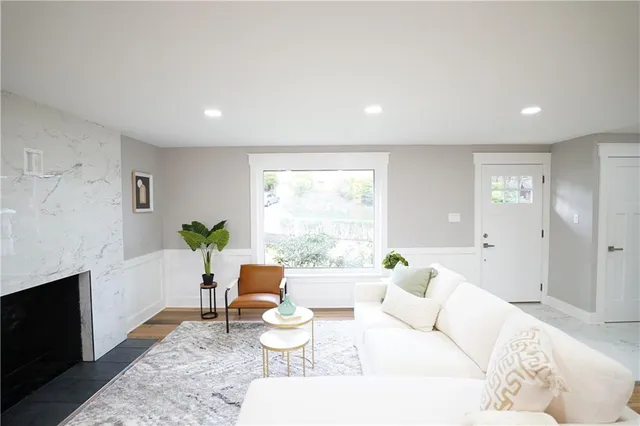 a living room with furniture a window and a fireplace