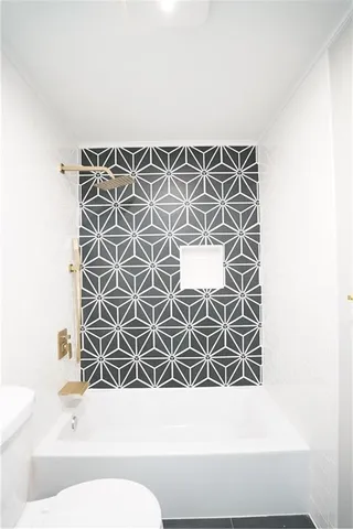 a bathroom with a toilet a sink and a shower