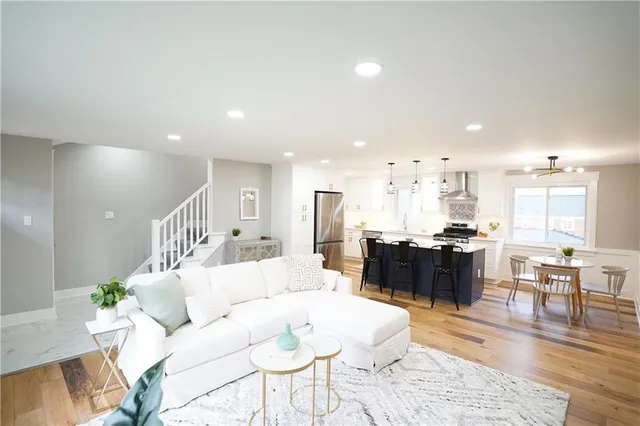 a living room with furniture or kitchen view and a wooden floor