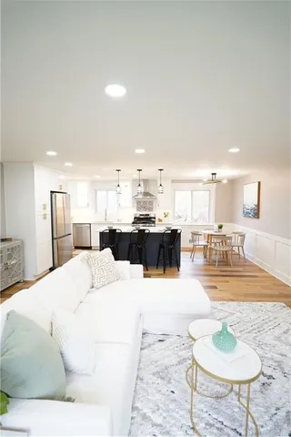 a living room with kitchen island furniture and a wooden floor