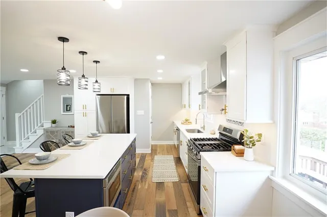 a kitchen with a table chairs stove and refrigerator
