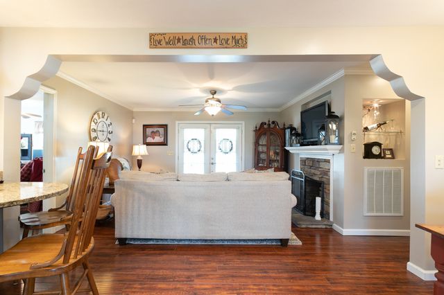 a living room with furniture and a chandelier