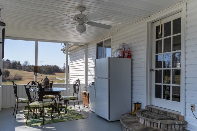 a view of a dining room with furniture and front door