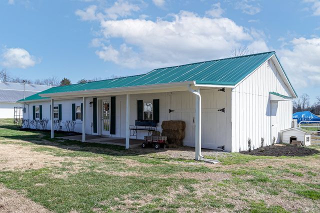 a kitchen with a table chairs stove and cabinets