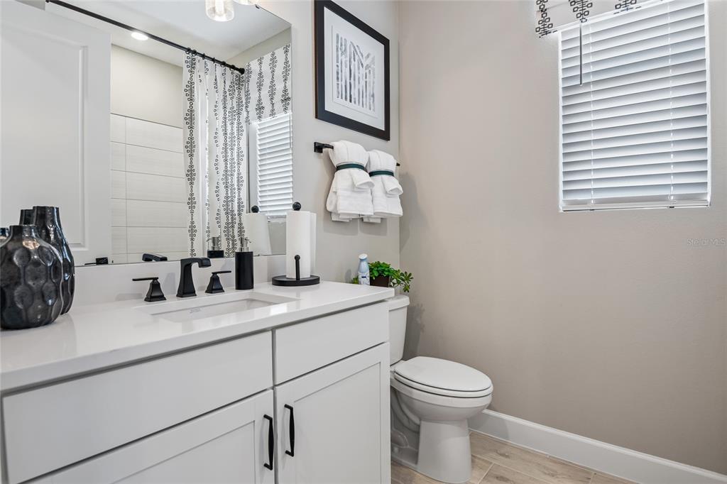 6418 Clover Street Lake Hamilton, FL 33844 - Photo 12 of 14 a bathroom with a granite countertop sink mirror vanity and toilet