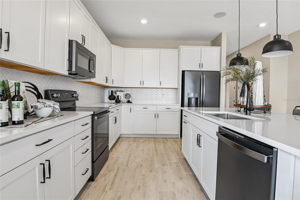 6418 Clover Street Lake Hamilton, FL 33844 - Photo 6 of 14 a kitchen with cabinets and stainless steel appliances
