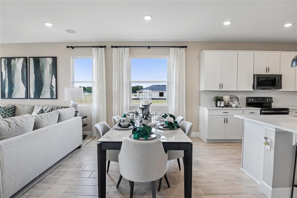6418 Clover Street Lake Hamilton, FL 33844 - Photo 7 of 14 a living room with furniture a couch and a flat screen tv
