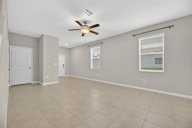 a view of a kitchen with a refrigerator a microwave and a sink