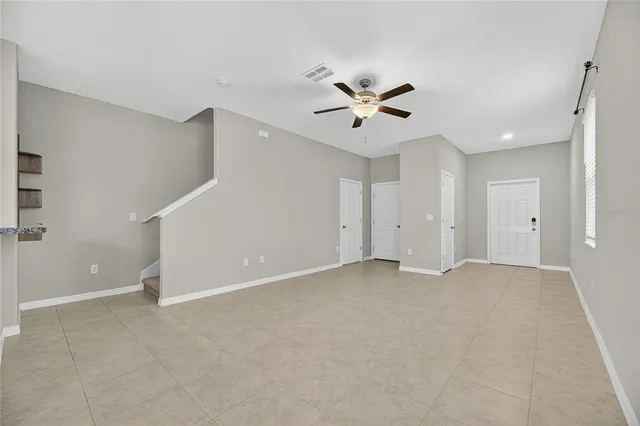 a kitchen with stainless steel appliances kitchen island granite countertop a refrigerator a sink a stove a microwave and a counter top space