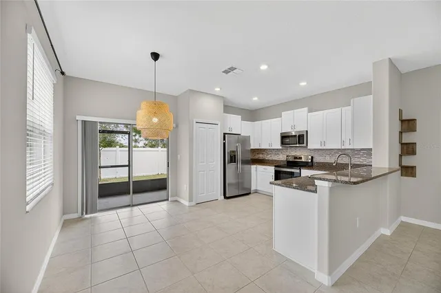 a kitchen with stainless steel appliances granite countertop a sink and cabinets
