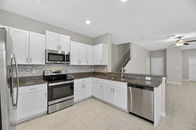 a view of an empty room with window and bathroom