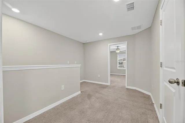 a view of a hallway with wooden shelves