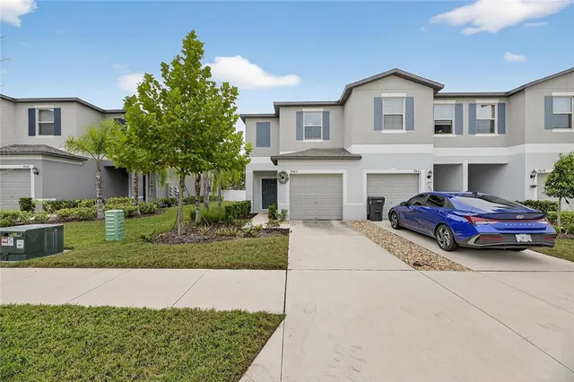 a view of a house with swimming pool and a yard