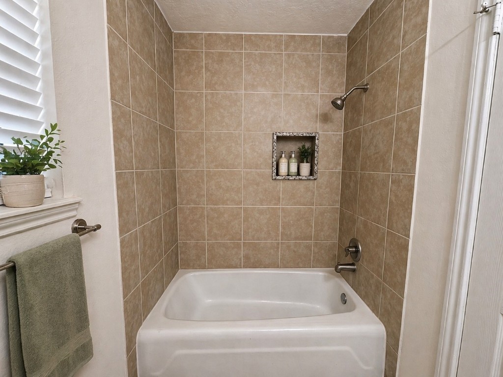 2402 Barak Lane Bryan, TX 77802 - Photo 11 of 25 a bathroom with a shower and a bathtub