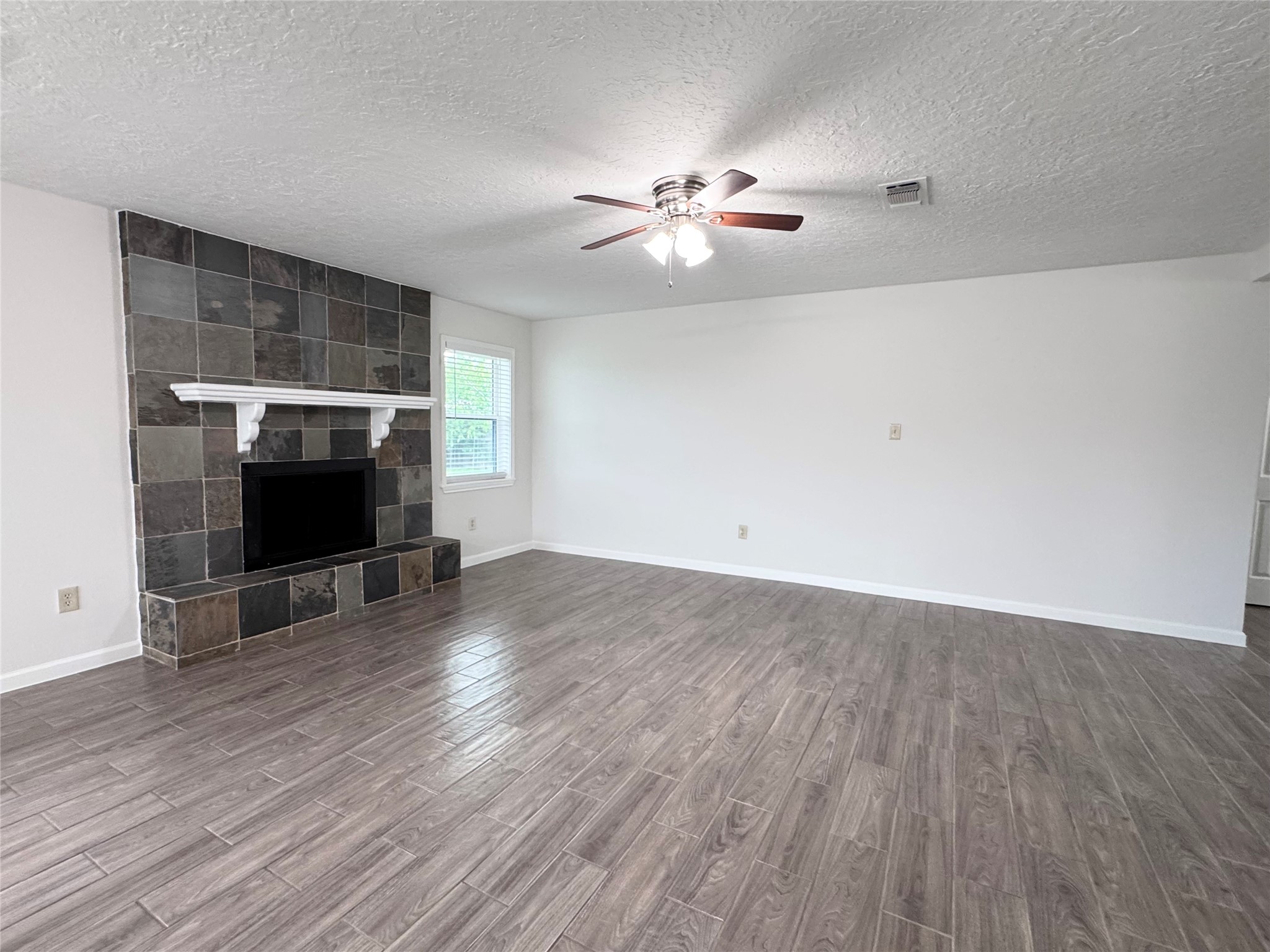 2402 Barak Lane Bryan, TX 77802 - Photo 18 of 25 a view of empty room with wooden floor and fan
